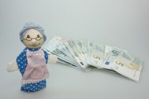 puppet, granny, children's toys, wood, to play, nostalgia, nostalgic, money, banknotes, euro, save up, savings book, pension, apron, pension cut, pension increase, pocket money, pension, pension, pension, pension, pension, pocket money